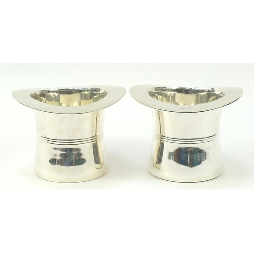 416 - Pair of silver plated Champagne ice buckets in the form of top hats, 18cm high x 24cm in diameter