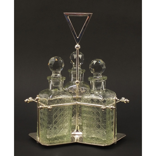 417 - Modernist silver plated three bottle tantalus with glass decanters in the style of Christopher Dress... 