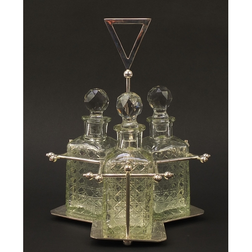 417 - Modernist silver plated three bottle tantalus with glass decanters in the style of Christopher Dress... 