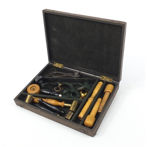 102 - Antique gun ammunition making equipment including a cartridge maker, clamps and scissors housed in a... 