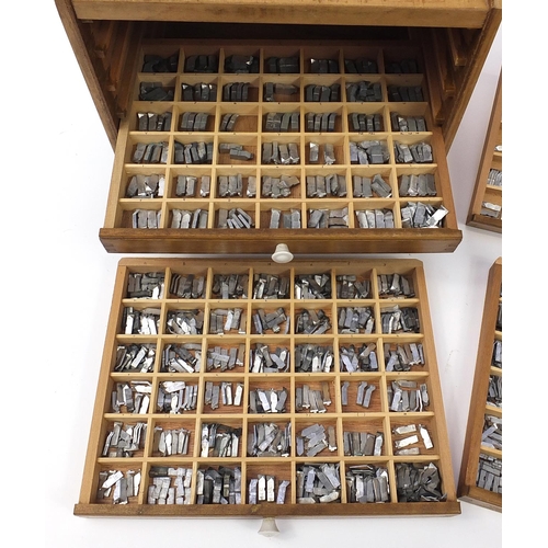 345 - Large collection of metal printer's blocks letterpresses arranged in a six drawer table top cabinet