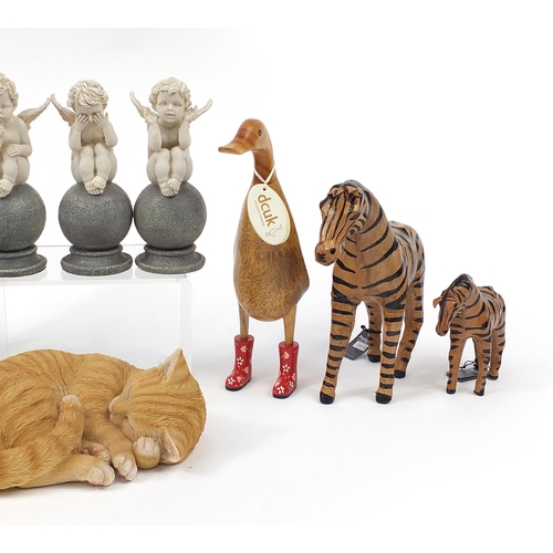 1393 - Decorative animals and figurines including two zebras and a wooden duck, the largest 54cm high
