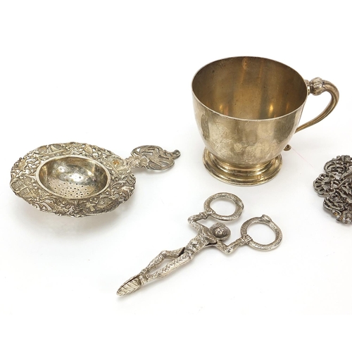 2223 - Sterling silver cup, naturalistic silver straining spoon and a white metal two piece buckle and nove... 