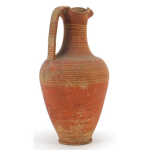 113 - Geometric trefoil lipped pottery jug with red painted circles, 24cm high
