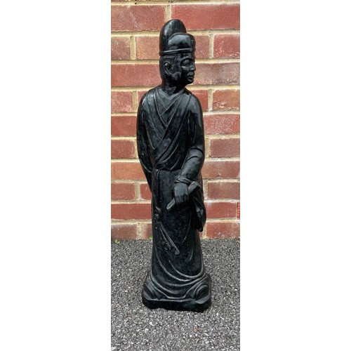 299 - Large Chinese carved green/black stone figure of a standing figure holding a scroll, 69cm high