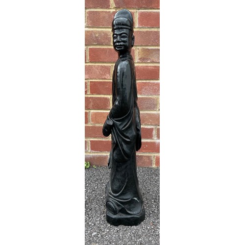 299 - Large Chinese carved green/black stone figure of a standing figure holding a scroll, 69cm high