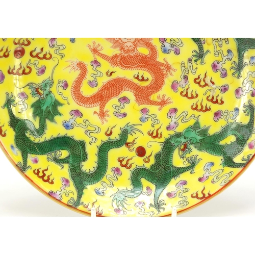 438 - Chinese porcelain shallow dish hand painted with dragons and bats, blue character marks to the base,... 