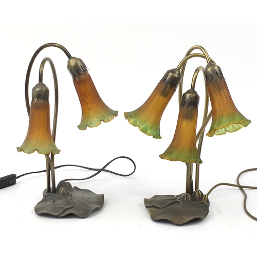 1897 - Two Tiffany design bronzed lily pad lamps with glass shades, 40cm high