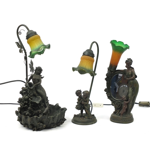 1898 - Three bronzed table lamps with glass shades including a mermaid water feature and mirror, the larges... 