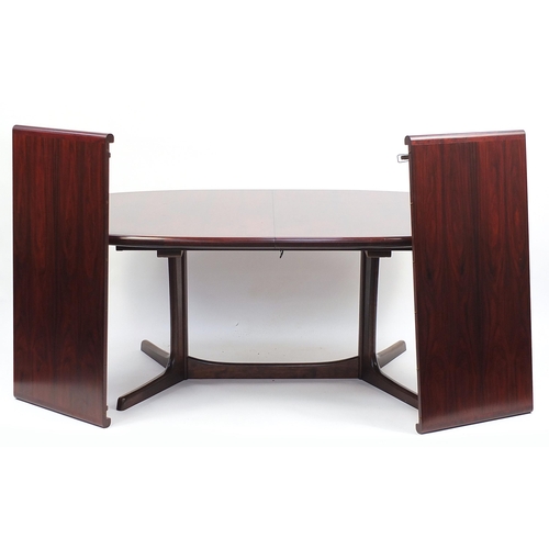 693 - Dyrlund, Danish rosewood extending dining table with two extra leaves and six chairs, including two ... 