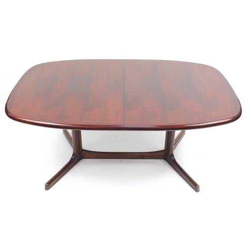 693 - Dyrlund, Danish rosewood extending dining table with two extra leaves and six chairs, including two ... 