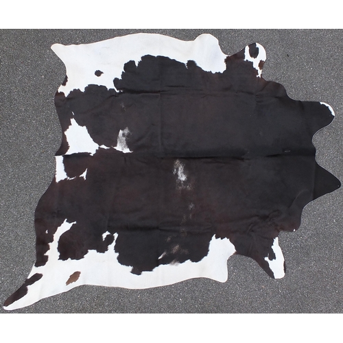 661A - Contemporary full size cow hide rug, approximately 230cm x 200cm