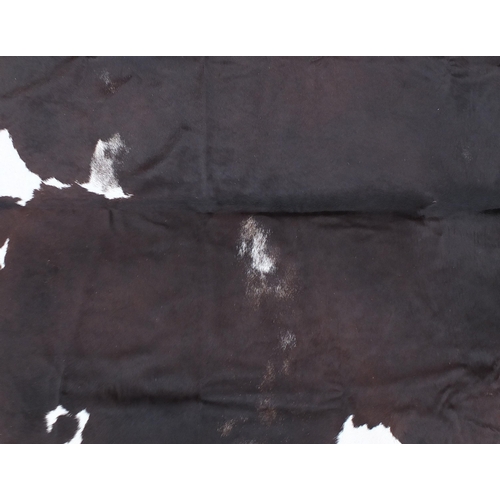 661A - Contemporary full size cow hide rug, approximately 230cm x 200cm