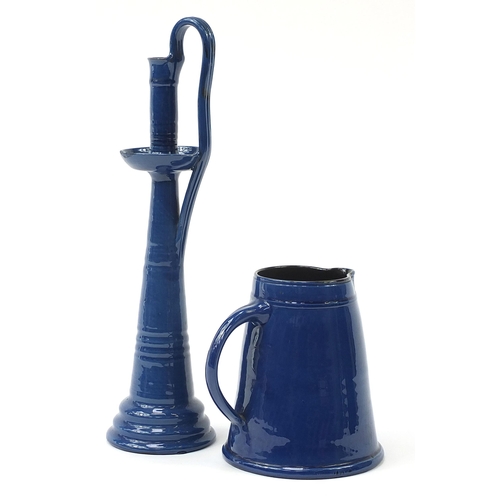 89 - C H Brannam pottery blue glazed jug and a similar candlestick, the largest 44cm high