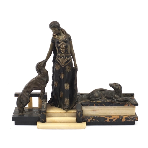 115 - French Art Deco marble, onyx and patinated spelter sculpture of a female and two dogs, 52cm wide