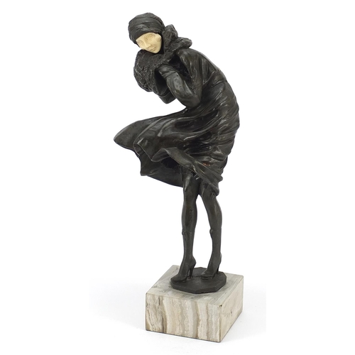 175 - Art Deco design bronzed figurine raised on a simulated marble base, 31cm high