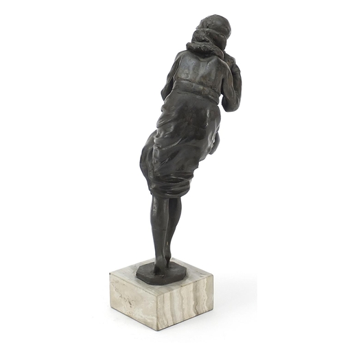 175 - Art Deco design bronzed figurine raised on a simulated marble base, 31cm high