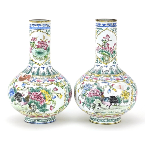 439 - Pair of Canton enamelled vases hand painted with birds of paradise amongst flowers, 15.5cm high