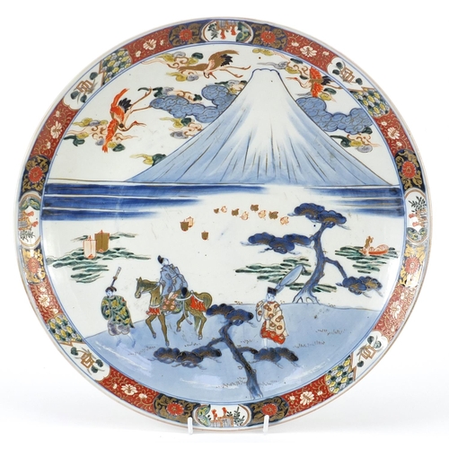 296 - Japanese porcelain charger hand painted with figures before Mount Fuji, character marks to the base,... 
