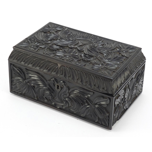 413 - Anglo Indian Ceylonese ebony casket profusely carved with flowers, 11.5cm H x 24cm W x 15.5cm D