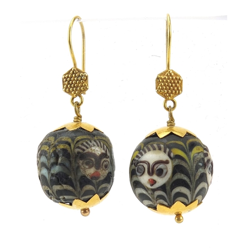 2798 - Pair of Islamic unmarked gold mounted glass earrings, hand painted with face masks, 4cm high, 13.0g