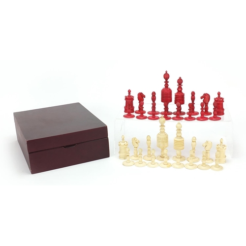 1958 - Half stained carved bone chess set, the largest pieces 12cm high