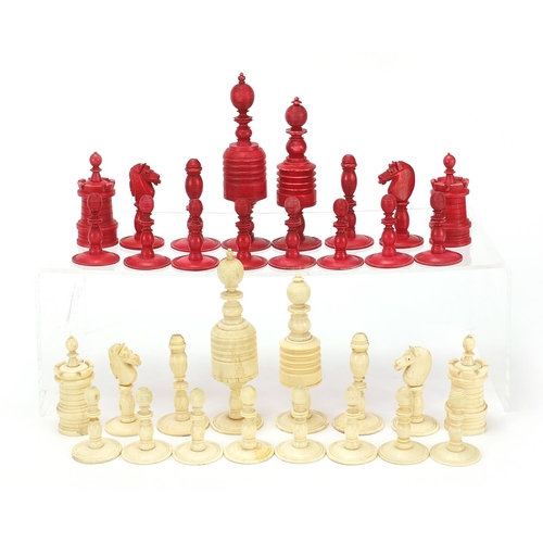 1958 - Half stained carved bone chess set, the largest pieces 12cm high