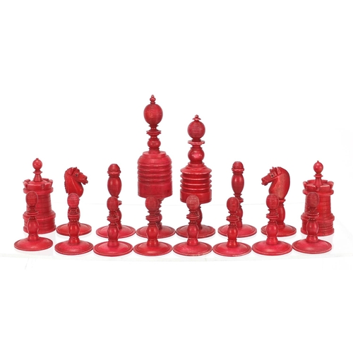 1958 - Half stained carved bone chess set, the largest pieces 12cm high