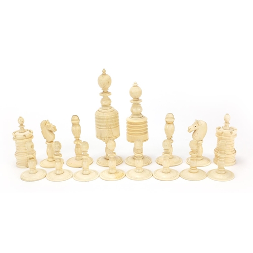 1958 - Half stained carved bone chess set, the largest pieces 12cm high