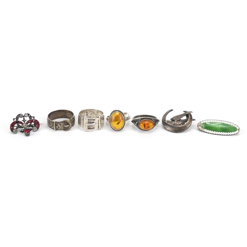 2767 - Antique and later silver jewellery including a guilloche enamel brooch, amber rings and buckle rings... 