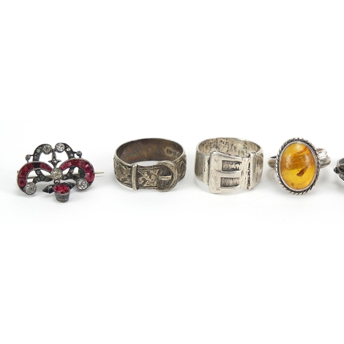 2767 - Antique and later silver jewellery including a guilloche enamel brooch, amber rings and buckle rings... 