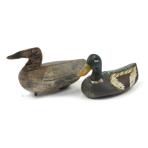 664 - Two antique carved wood duck decoys, the largest 39cm in length