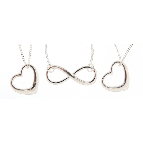 2800 - Three silver heart and bow design pendants on necklaces