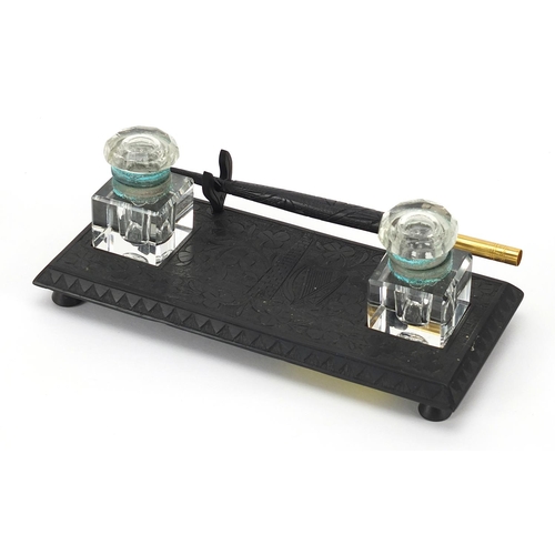 410 - Irish bog oak desk stand with dip pen and cut glass inkwells, 17.5cm wide