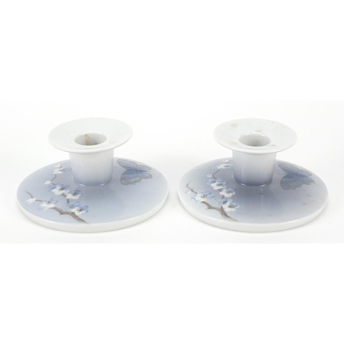 11 - Royal Copenhagen, pair of Danish porcelain squat candlesticks hand painted with butterflies and flow... 