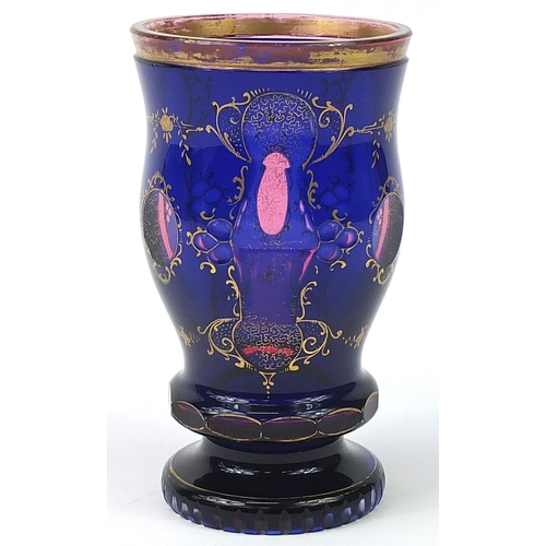 267 - Bohemian blue overlaid glass goblet gilded with flowers, 16cm high