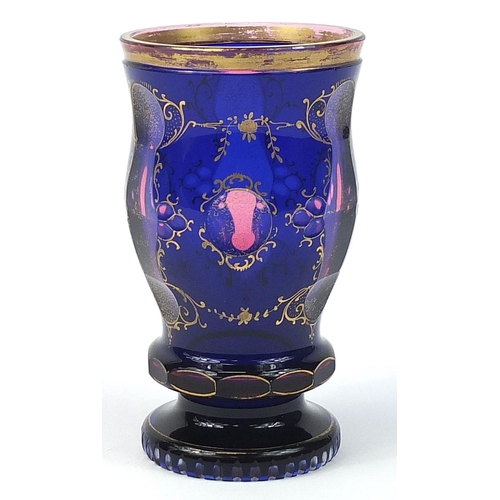 267 - Bohemian blue overlaid glass goblet gilded with flowers, 16cm high