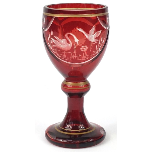 153 - Bohemian ruby overlaid glass goblet etched with two geese, 19.5cm high