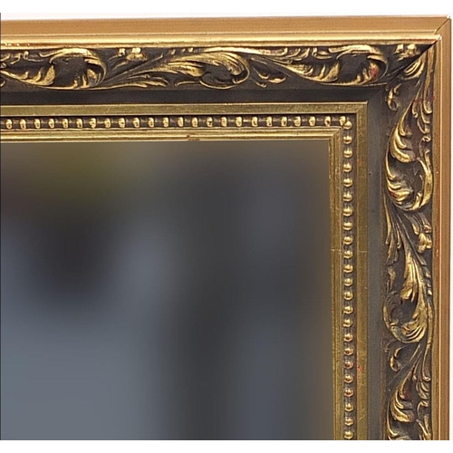 705 - Ornate gilt framed wall hanging mirror with bevelled glass, 90cm x 65cm