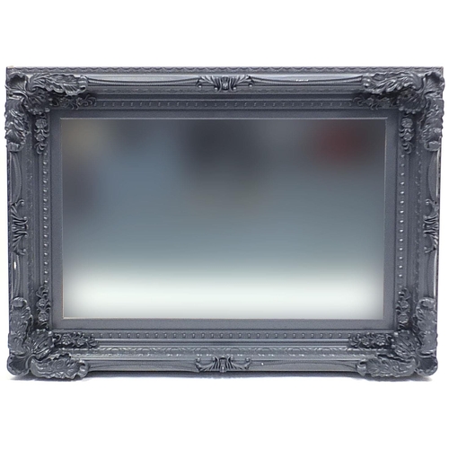 695 - Large ornate framed wall hanging mirror with bevelled glass, 120cm x 86cm