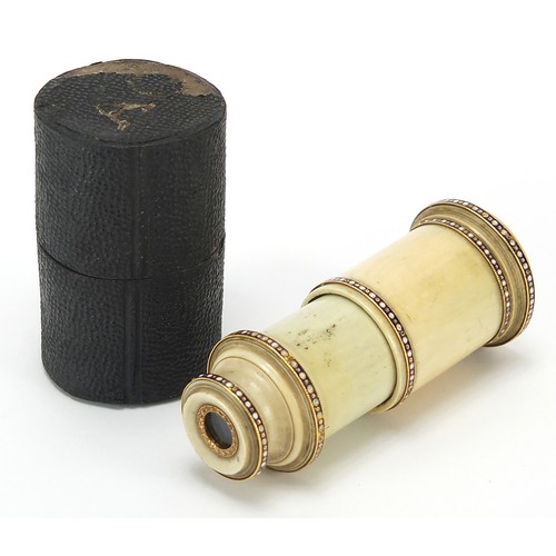 423 - Georgian ivory monocular with enamelled unmarked gold mounts and case, 6.5cm in length when closed