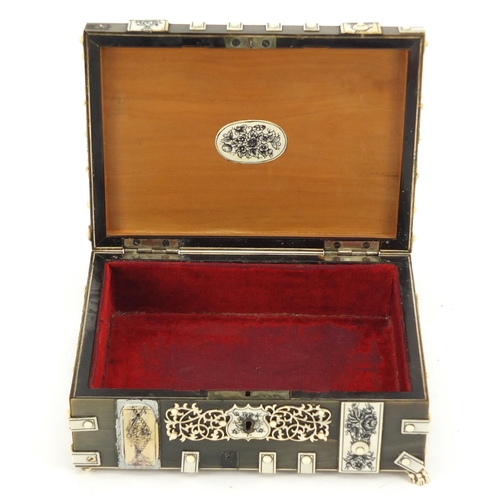 414 - Anglo Indian horn, sandalwood and ivory dome topped casket on paw feet, the ivory penwork panels dec... 