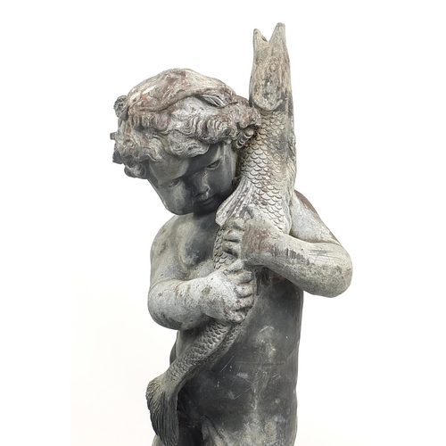 688a - Lead garden water feature of Putti holding a fish, raised on a square concrete base, 145cm high