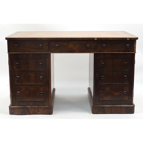 699A - Rosewood twin pedestal desk with tooled leather insert above a series of drawers, 74cm H x 123cm W x... 