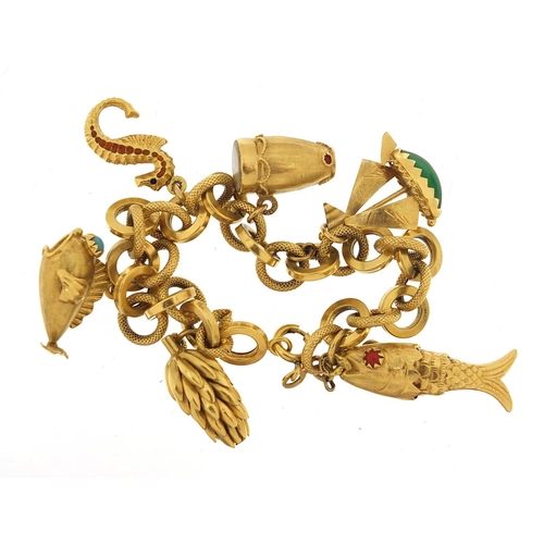 23 - 18ct gold charm bracelet with a selection of gold charms including enamelled seahorse, drum with mot... 