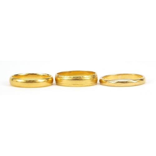 49 - Three 22ct gold wedding bands, sizes L and O, 10.9g - this lot is sold without buyer’s premium, the ... 