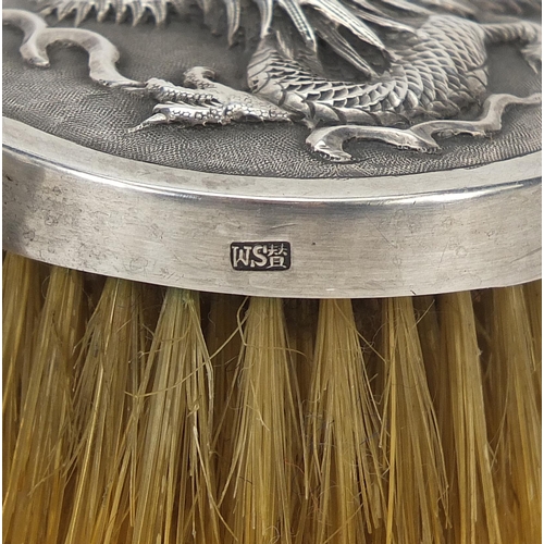 39 - Pair of Chinese silver backed brushes embossed with dragons by Woshing, 13cm wide