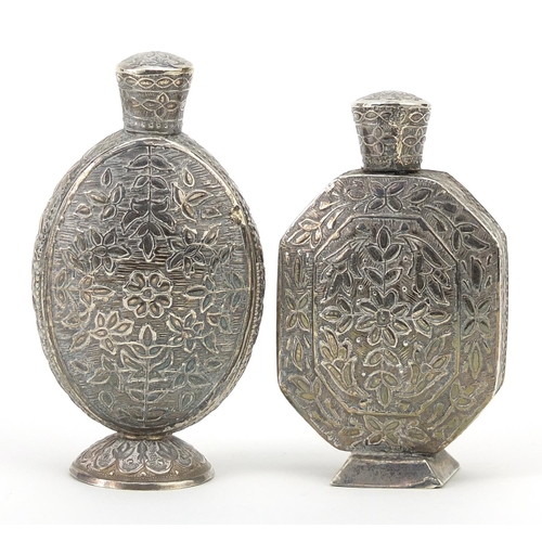 63 - Two Persian unmarked silver scent bottles engraved with flowers and foliage, the largest 8.1cm high,... 