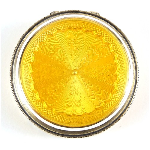 21 - Continental 935 silver and yellow guilloche enamel pill box with hinged lid and mirrored interior, i... 