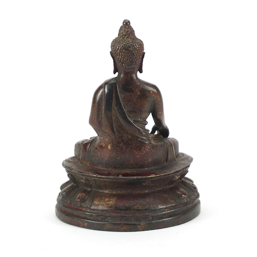 1299 - Chino Tibetan partially gilt bronze figure of seated Buddha, 14cm high